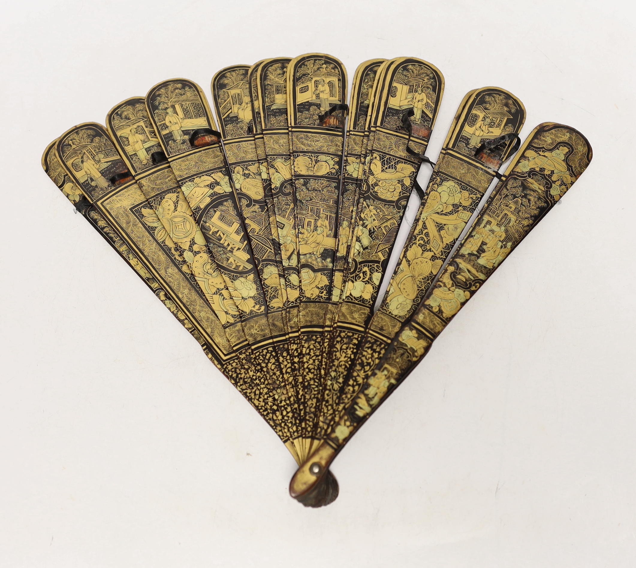 A mid 19th century Chinese gilt decorated black lacquer brise fan, 23cm in length